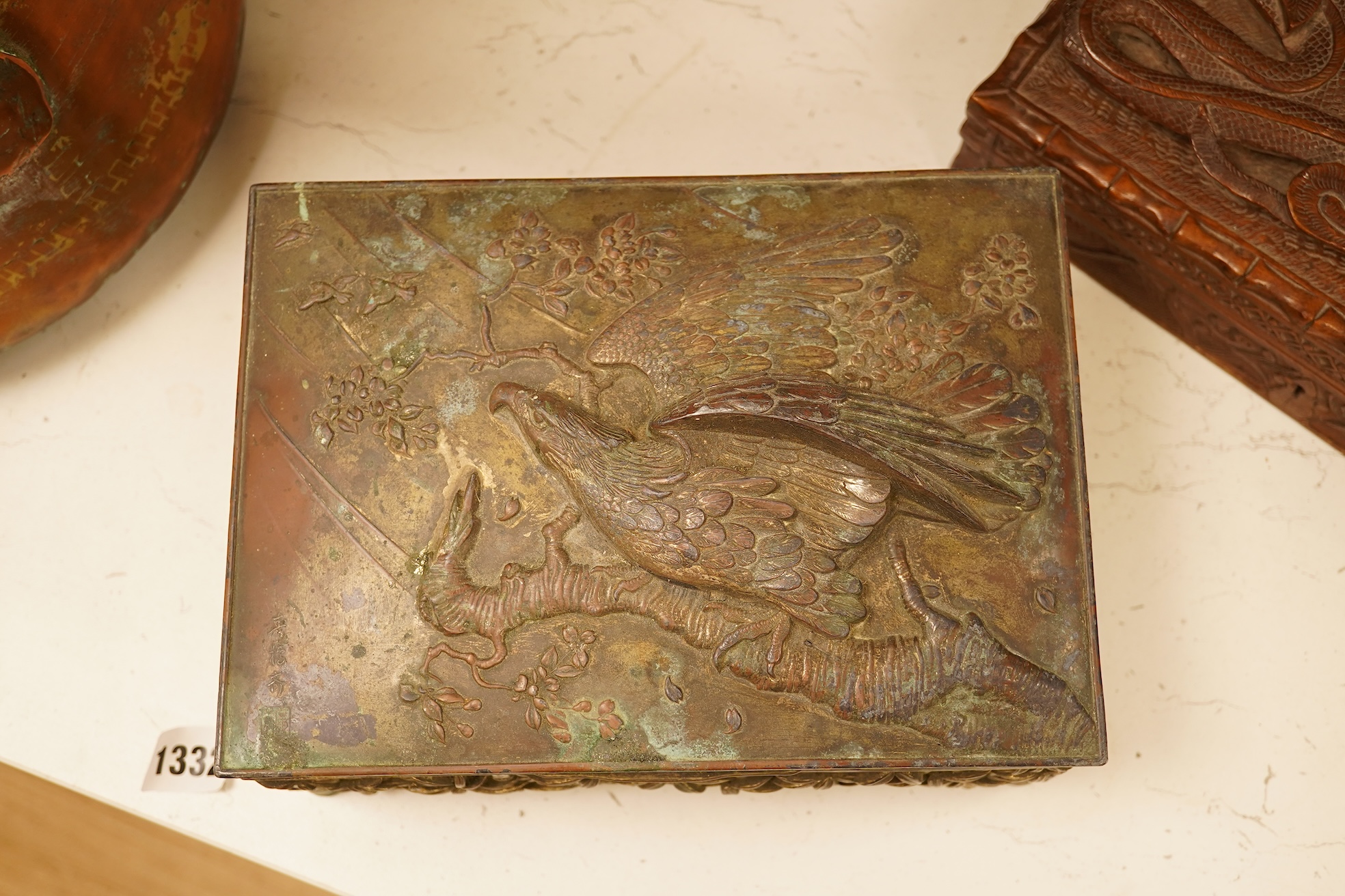A late 19th century Japanese gilt metal lidded box together with a Burmese carved hardwood box, 28cm wide